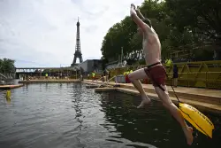 Joyful Parisians take a historic plunge into the Seine River after 100 years