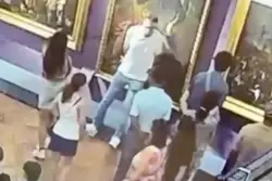Bumbling tourist trips and puts hand through 300-year-old painting while posing for photo